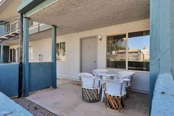 A patio with a table and chairs is visible.